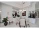 Dining room boasts glass table, seating for six, and elegant light fixture at 5733 White Jasmine Way, North Port, FL 34287