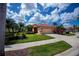 Charming single-story home boasts a lovely tile roof, a two-car garage, and mature trees at 5733 White Jasmine Way, North Port, FL 34287
