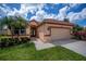 Beautiful single-story home features a well-manicured lawn, mature trees, and a two-car garage at 5733 White Jasmine Way, North Port, FL 34287