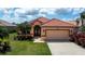 Attractive single-Gathering home with a well-manicured lawn, a two-car garage, and lush landscaping at 5733 White Jasmine Way, North Port, FL 34287