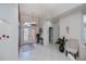 Bright foyer with tile flooring, decorative glass doors, and a stylish accent wall at 5733 White Jasmine Way, North Port, FL 34287