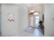 Welcoming foyer with a glass double-door entry and elegant lighting fixture at 5733 White Jasmine Way, North Port, FL 34287