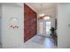 Elegant foyer with a decorative rug, glass double doors, and an ornate chandelier at 5733 White Jasmine Way, North Port, FL 34287