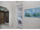 Hallway with painting and view to the lanai at 5733 White Jasmine Way, North Port, FL 34287