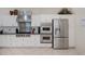 Chef's kitchen featuring a range hood, stainless steel appliances, and ample cabinet space at 5733 White Jasmine Way, North Port, FL 34287