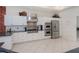 Gourmet kitchen featuring stainless steel appliances, granite countertops, and white cabinets at 5733 White Jasmine Way, North Port, FL 34287