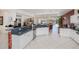 Open-concept kitchen with stainless steel appliances, granite counters, and a view of the pool at 5733 White Jasmine Way, North Port, FL 34287