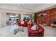 Living room features a view to the pool and lake through sliding glass doors, as well as designer wall details at 5733 White Jasmine Way, North Port, FL 34287