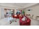 Living room features a view to the pool and lake through sliding glass doors and tile flooring throughout at 5733 White Jasmine Way, North Port, FL 34287