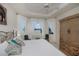 Airy main bedroom features a decorative bed frame, tray ceiling, and windows with a view of the outdoors at 5733 White Jasmine Way, North Port, FL 34287
