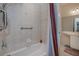 Modern shower with adjustable shower head, safety bars, elegant tile, with view to vanity at 5733 White Jasmine Way, North Port, FL 34287