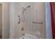 Modern shower with adjustable shower head, safety bars, and elegant tile work at 5733 White Jasmine Way, North Port, FL 34287