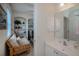 A sitting room featuring shelving, day bed and connected bathroom with bright vanity at 5733 White Jasmine Way, North Port, FL 34287