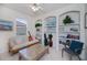 Comfortable sitting room featuring shelving and a decorative guitar at 5733 White Jasmine Way, North Port, FL 34287