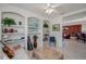 Comfortable sitting room with decorative shelving, with view to leather seating area at 5733 White Jasmine Way, North Port, FL 34287