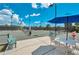 Tennis court with shaded seating area to observe the game at 5733 White Jasmine Way, North Port, FL 34287