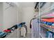 Walk-in closet with wire shelving and tile floors at 5733 White Jasmine Way, North Port, FL 34287