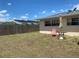 Backyard featuring well-kept grass and patio seating, ideal for enjoying outdoor relaxation and sunshine at 6327 Fabian Rd, North Port, FL 34287
