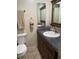 Bathroom featuring a toilet, vanity with dark cabinets and gray countertop, and neutral tile flooring at 6327 Fabian Rd, North Port, FL 34287