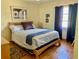 Comfortable bedroom featuring a wooden bed frame, ample natural light, and warm tile floors at 6327 Fabian Rd, North Port, FL 34287