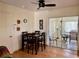 Cozy dining area featuring a dark wood table, tiled floors, and sliding glass doors to the outdoors at 6327 Fabian Rd, North Port, FL 34287
