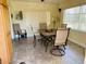 Bright dining area with tile floors, table, and chairs with ample natural light at 6327 Fabian Rd, North Port, FL 34287