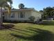 Charming home with manicured lawn, complemented by lush trees and well-maintained landscaping at 6327 Fabian Rd, North Port, FL 34287
