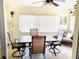 Relaxing Florida room features tiled floors, ceiling fan, tile table, and comfortable seating, ideal for unwinding at 6327 Fabian Rd, North Port, FL 34287