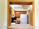 Pass-through view of kitchen with wooden cabinets, tiled backsplash, and appliances at 6327 Fabian Rd, North Port, FL 34287