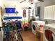 Organized laundry room with a washer, dryer, storage shelves, and ample space for cleaning supplies at 6327 Fabian Rd, North Port, FL 34287
