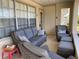 Comfortable seating for relaxing on the cozy patio with large windows and covered area at 6327 Fabian Rd, North Port, FL 34287