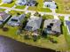 Aerial view of waterfront homes with screened-in pools and well-maintained lawns in a residential neighborhood at 1091 Rotonda Cir, Rotonda West, FL 33947