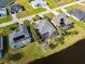 Aerial view of three homes side-by-side with screened-in pools and palm tree landscaping in the back at 1091 Rotonda Cir, Rotonda West, FL 33947