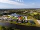 Aerial view of a charming neighborhood with waterfront homes surrounding a central lake and golf course at 1091 Rotonda Cir, Rotonda West, FL 33947