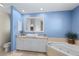 This bathroom offers a relaxing soaking tub and vanity with granite countertops at 1091 Rotonda Cir, Rotonda West, FL 33947