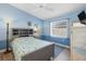 Cozy bedroom featuring blue accent walls, comfortable furnishings, and ample natural light from the window at 1091 Rotonda Cir, Rotonda West, FL 33947