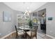 Bright breakfast nook with modern chandelier and views of backyard at 1091 Rotonda Cir, Rotonda West, FL 33947