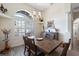 Traditional dining room featuring a dark wood table with seating for eight, complemented by a charming chandelier at 1091 Rotonda Cir, Rotonda West, FL 33947