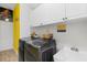 Well-equipped laundry room with washer, dryer, utility sink, and ample storage at 1091 Rotonda Cir, Rotonda West, FL 33947