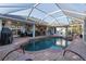 A refreshing screened-in pool, with outdoor seating area, perfect for relaxation and entertaining at 1091 Rotonda Cir, Rotonda West, FL 33947