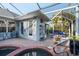Cozy outdoor space featuring a screened-in pool, patio, and access to pool house at 1091 Rotonda Cir, Rotonda West, FL 33947