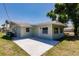 Backyard with a concrete patio and lush green lawn beneath a clear blue sky at 1357 Nimrod St, Port Charlotte, FL 33952