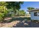 Spacious backyard featuring a large tree that creates shade, offering a peaceful outdoor space and privacy at 1357 Nimrod St, Port Charlotte, FL 33952
