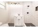 Bathroom featuring a white vanity and walk-in shower with white subway tile at 1357 Nimrod St, Port Charlotte, FL 33952