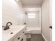 Stylish bathroom with white subway tile, modern vanity, and updated fixtures at 1357 Nimrod St, Port Charlotte, FL 33952