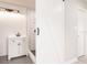 Bathroom featuring a modern vanity and a subway-tiled shower behind a white barn door at 1357 Nimrod St, Port Charlotte, FL 33952