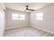 Bedroom features wood-look flooring, a ceiling fan, and two windows at 1357 Nimrod St, Port Charlotte, FL 33952