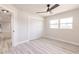 Bright bedroom featuring wood-look floors, a ceiling fan, and double door closet at 1357 Nimrod St, Port Charlotte, FL 33952