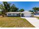 Charming single-story home with a well-maintained lawn and a new driveway leading to an attached garage at 1357 Nimrod St, Port Charlotte, FL 33952