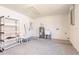 Well-lit garage with epoxy flooring, utility sink, and water heater, providing practicality and durability at 1357 Nimrod St, Port Charlotte, FL 33952
